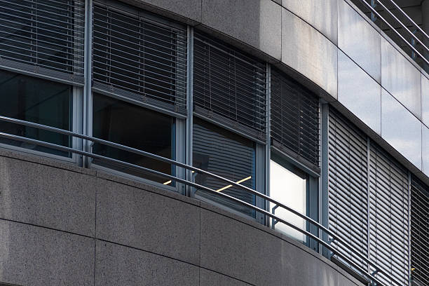 istock A modern office facade with rhythmic horizontal lines, a long row of windows and metal shutters 2249941096