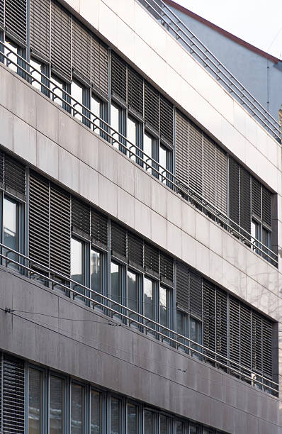 istock Modern office building with glass windows and external blinds in a strict minimalist urban style 2249941180