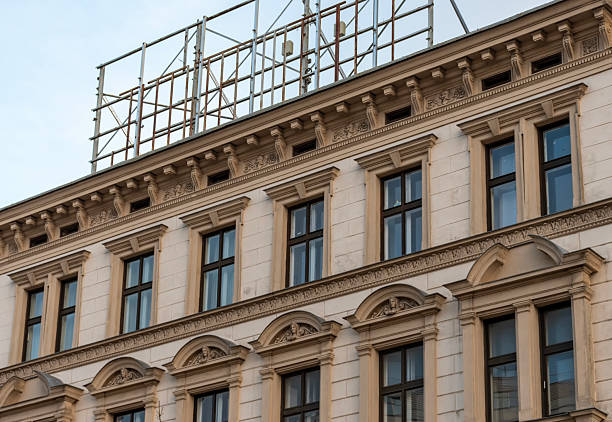 Apartment building under renovation covered in a scaffolding
