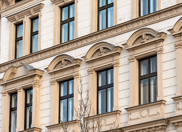 istock Facade of a historic building with decorative elements, arched niches and classic window frames 2249941296