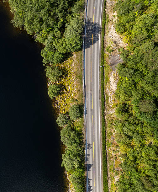 istock Aerial view highway road beside lake 2249946906