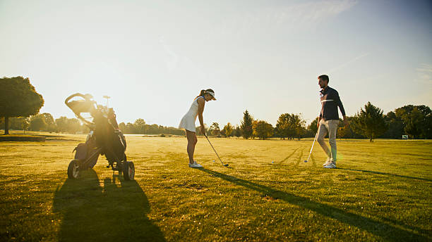 istock Woman Golfer and Coach Sharing Tips on Sunny Fairway 2249947346
