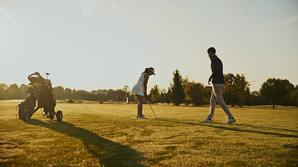 istock Caucasian Woman Discussing Golf Techniques with Coach on Fairway 2249947349