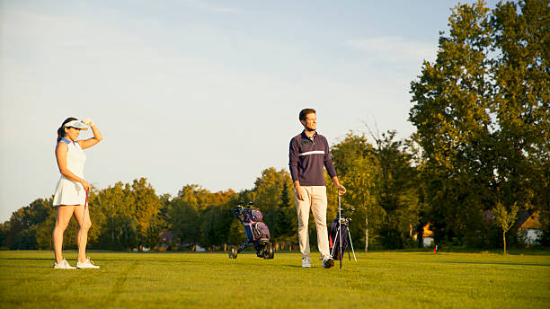 istock Caucasian Couple Relishing Golf on Bright Afternoon Course 2249947361