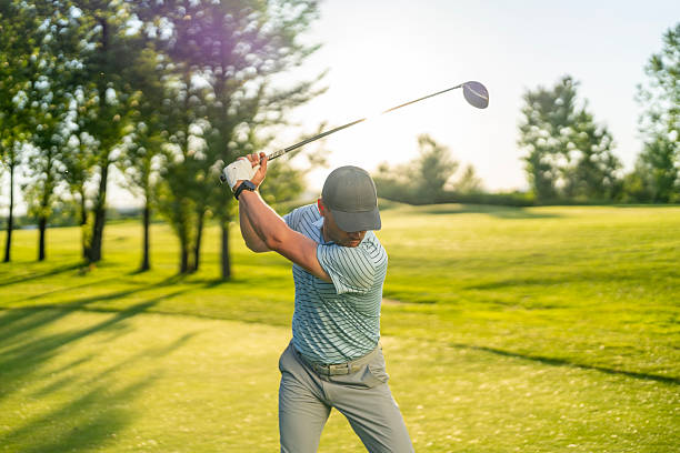 istock Caucasian Male Golfer Perfecting Swing Amidst Sunlit Trees on Golf Course 2249947366