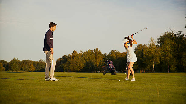 istock Mid Adult Caucasian Couple Sharing Golf Lessons on Open Course 2249947480