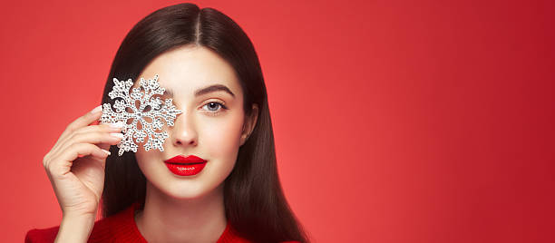 istock Beautiful young woman with glowing snowflake 2249947669