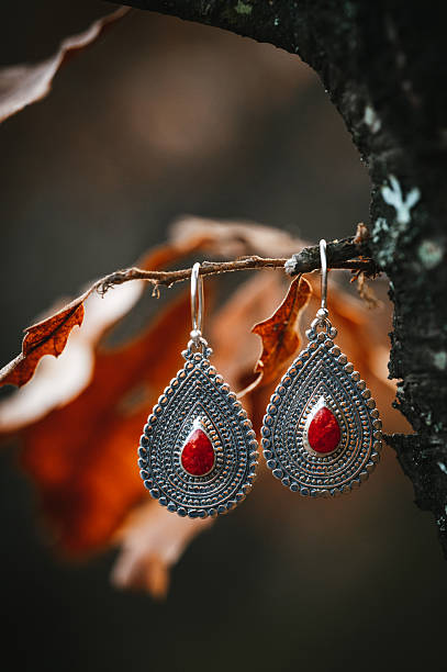 Traditional ethnic colorful silver earrings jewellery over blur background and copy space, Selective focus.