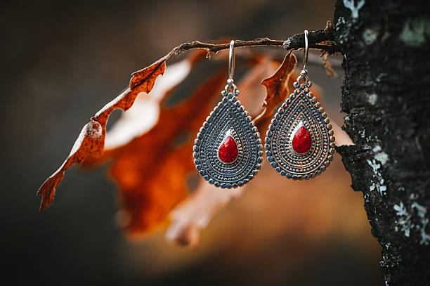 Coral and silver earrings in the nature