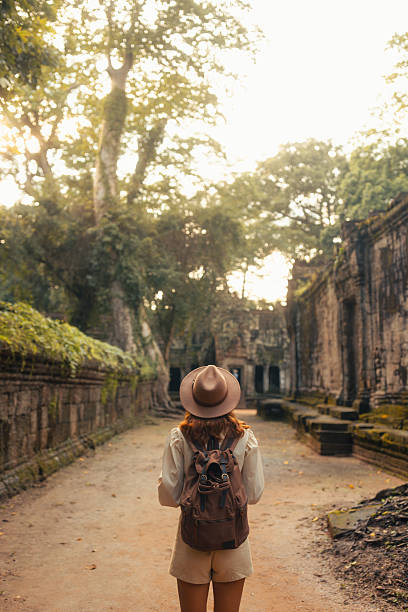 istock Female Traveler Walking Through Ancient Angkor Temple Passageway Ruins 2249956142