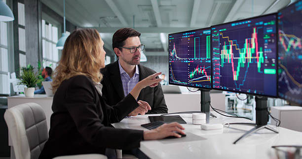 istock Busy Financial Agent Trading Stocks On Multiple Monitors 2249959076