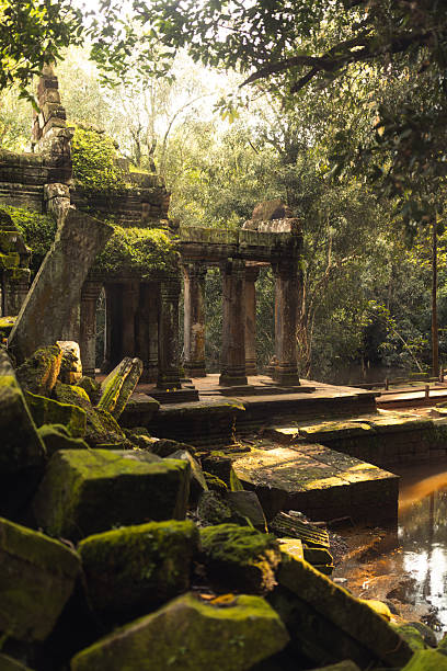 istock Moss Covered Angkor Temple Ruins Reflected In Tranquil Jungle Pond 2249959685