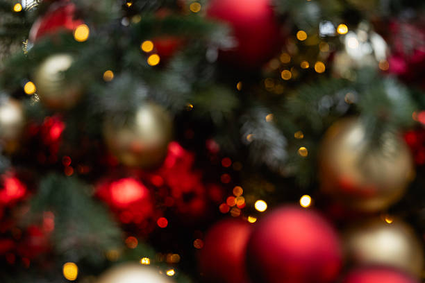 istock Blurred Christmas tree with golden garland and red balls. Abstract pattern. Xmas. 2249961278