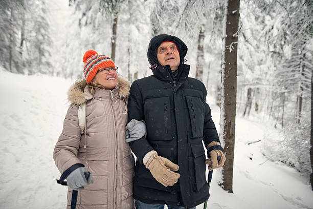 istock Senior couple walking in beautiful winter forest 2249961892
