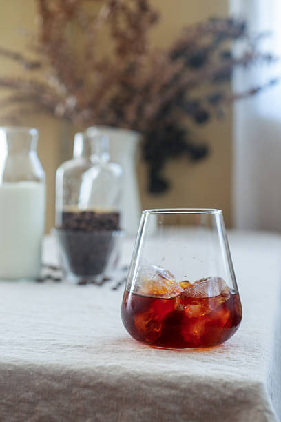istock Cold brew coffee in a clear glass with ice on a table. 2249964223