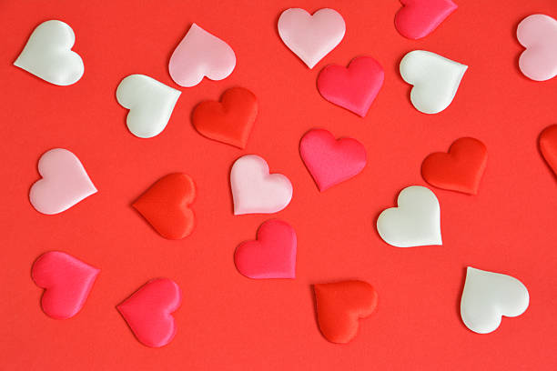 istock Scattered white, red and pink Hearts on Red Background 2249966256