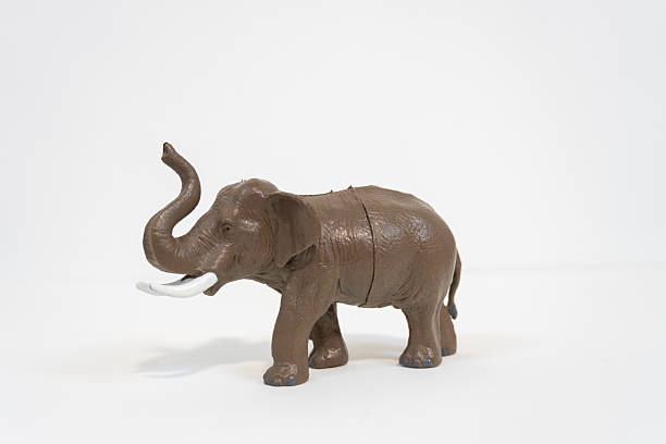istock Brown Elephant Toy Model with Raised Trunk 2249967997