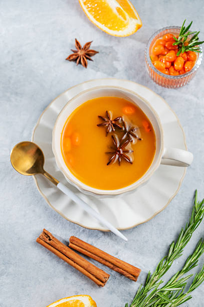 istock Sea buckthorn herbal tea in a cup on a light background with spices 2249968384