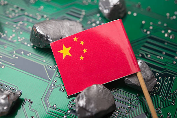 istock Chinese flag and mineral rare earth element on green electronic circuit board. 2249971154