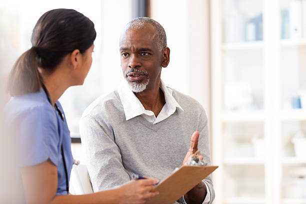 istock Patient discusses health concerns with nurse holding clipboard in office 2249972013