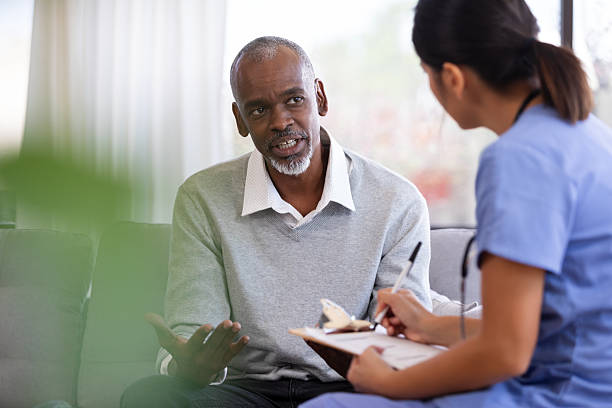 istock Man discussing concerns with a medical professional writing notes on a clipboard 2249972065