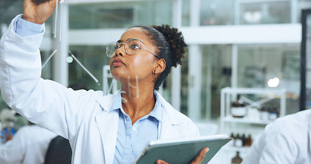 istock Woman, scientist and writing on glass with tablet for research, molecule structure and formula. Person, notes and diagram with digital for chemical compound, medical observation and equation in lab 2249973219