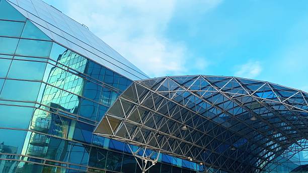 istock Modern glass building reflecting blue sky and cityscape 2249974150