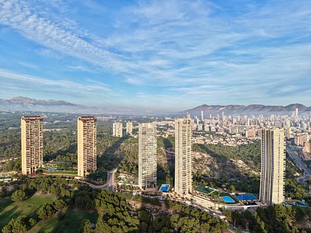 istock urban area meets mountain range, city sprawls towards towering mountains beneath clear bright sky 2249975104