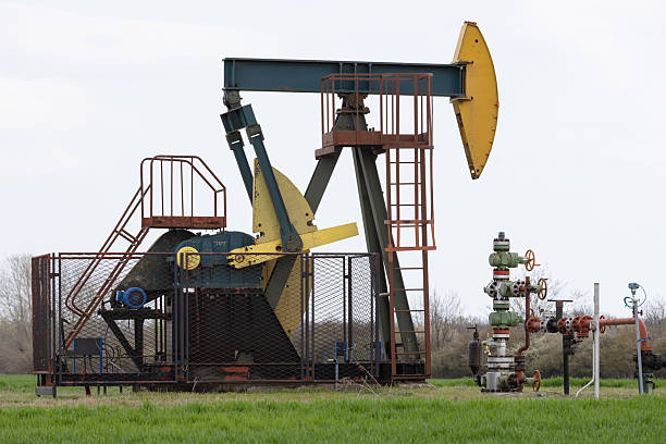 istock Oil Pump Jack in a Field on a Cloudy Day 2249975837