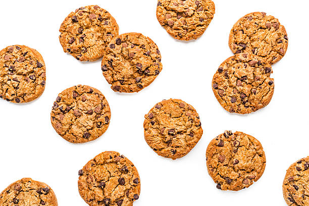 Group of crispy chocolate chips cookies shot from above on white background. Flat lay or copy space. Unhealthy sweet food