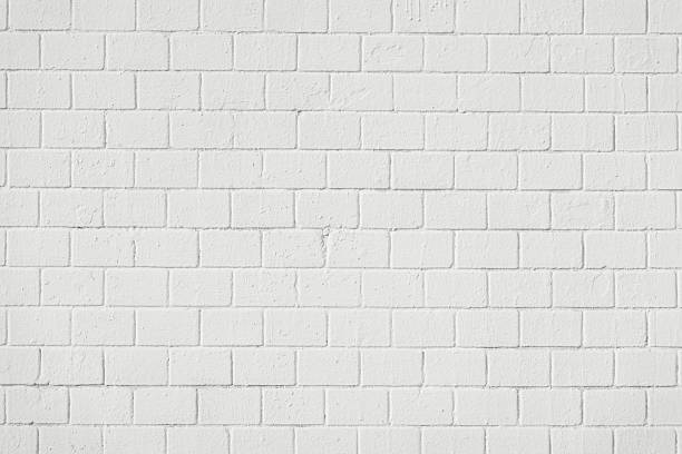 istock White painted brick wall with visible mortar lines and realistic texture, modern urban or industrial background in color of the year 2026 Cloud Dancer. Natural backdrop for design, mockups 2249977271