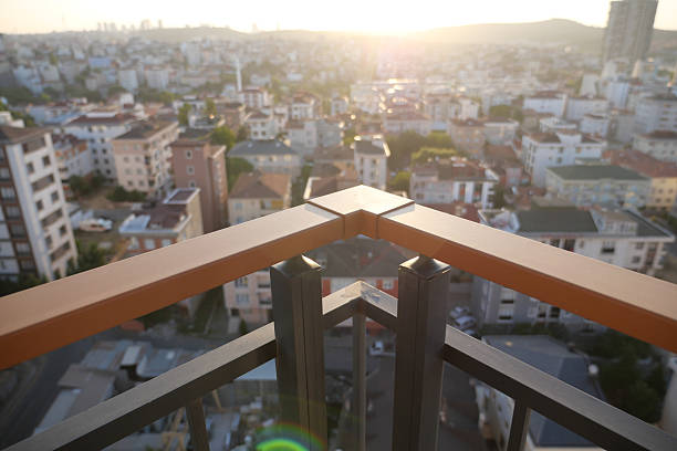 Overlooking a vibrant cityscape during sunset from a high balcony.
