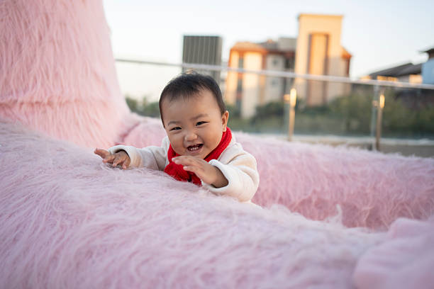 Asian babies playing and laughing happily on the terrace