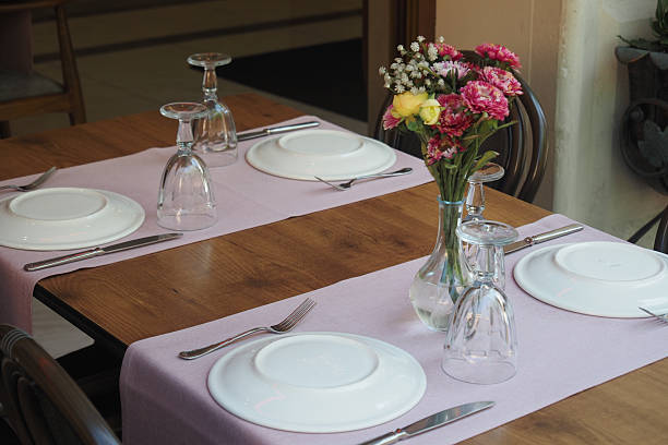 istock Elegant dining setup with flower centerpiece at a restaurant 2249983351