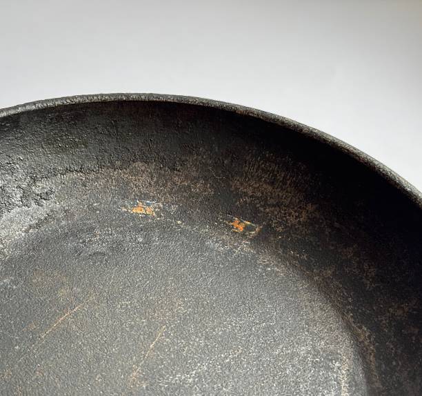 istock Old Cast-Iron Frying Pan with Rust and Patina - Vintage Cookware Surface Macro 2249985657