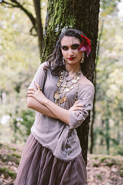 istock Elegant Young Woman Leaning on Tree in Forest 2249986887