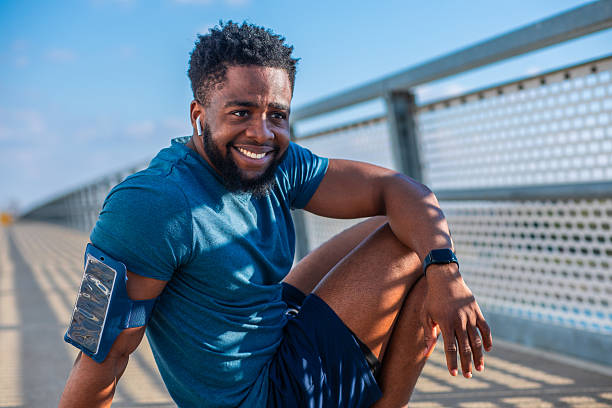 istock Smiling athlete sitting on bridge after workout 2249988165