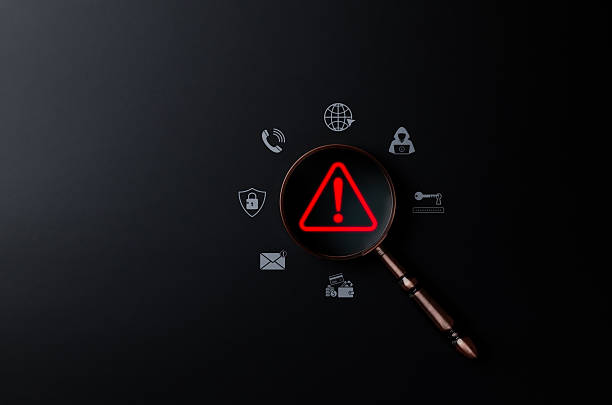 istock Cybersecurity threat detection concept. Magnifying glass on red alert symbol representing online risk, data breach, malware warning, scam, phishing, suspicious, unknown person, digital fraud awareness 2249989330