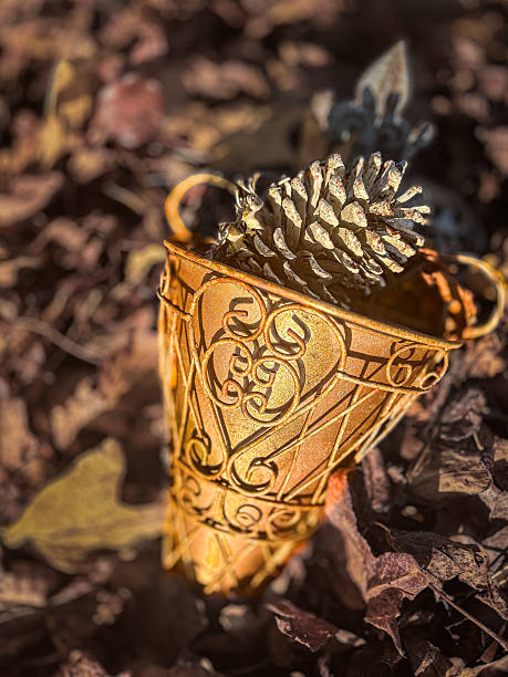 Pinecone in Decorative Gold Filigree Cup on Forest Floor