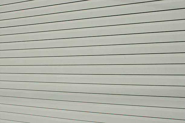 istock Horizontal lines cover a wall in a building during the daytime with shadows created by the light 2249989862