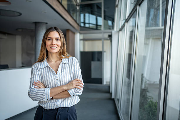 istock Businesswoman standing confidently in modern office hallway 2249990087