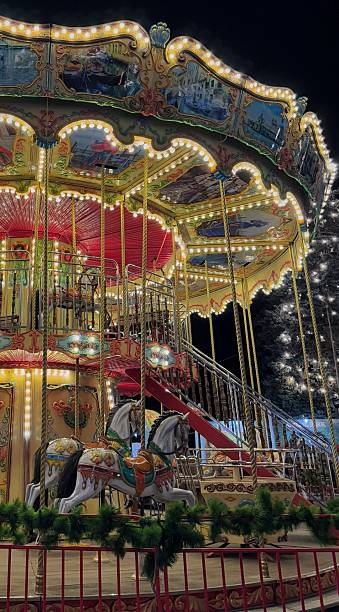 istock Vintage carousel with illuminated horses and decorated two level platform 2249990618