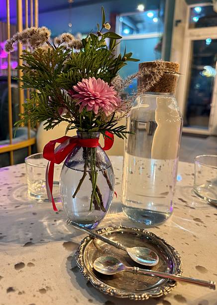 istock Table Still Life: Small Bouquet, Carafe and Silver Spoons 2249990783