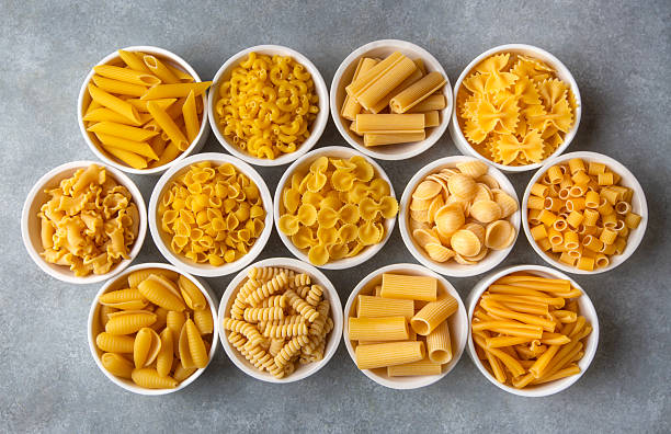 istock Composition with different tasty uncooked pasta - Italian pasta wallpaper, different types and shapes of pasta layout 2249993487