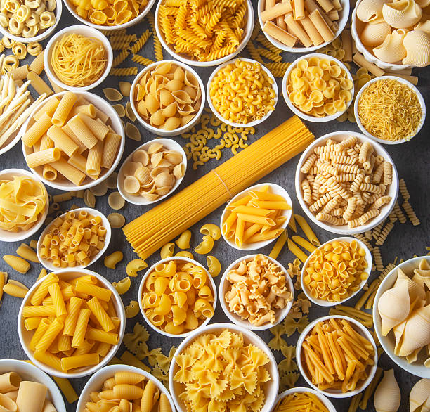 istock Composition with different tasty uncooked pasta - Italian pasta wallpaper, different types and shapes of pasta layout 2249994113