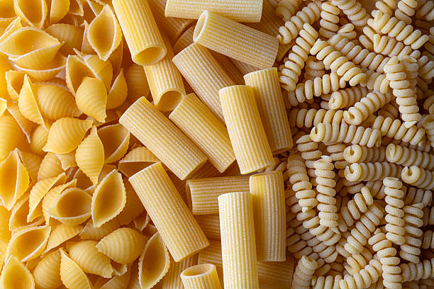 istock Composition with different tasty uncooked pasta - Italian pasta wallpaper, different types and shapes of pasta layout 2249994372