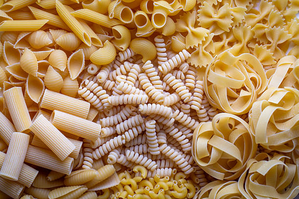 istock Composition with different tasty uncooked pasta - Italian pasta wallpaper, different types and shapes of pasta layout 2249994386