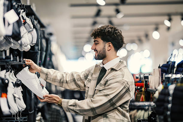 istock Man choosing new sneakers in a modern retail store 2249994590
