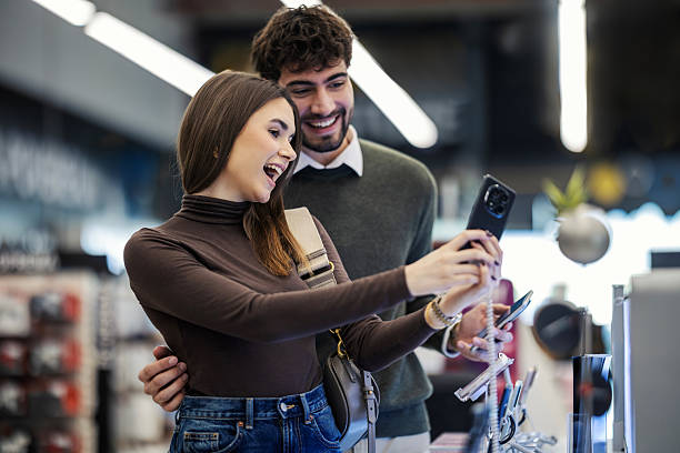 istock Happy couple shopping for smartphone in electronics store 2249995237