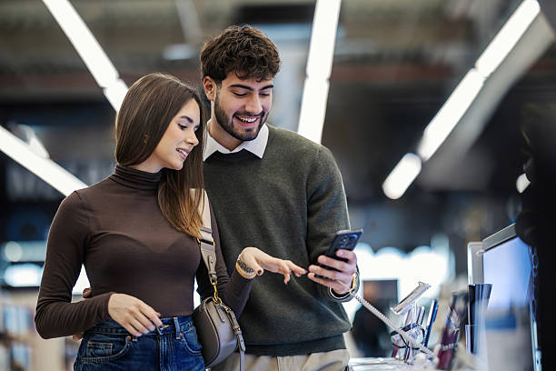 istock Young couple enjoying technology shopping experience in electronics store 2249995258